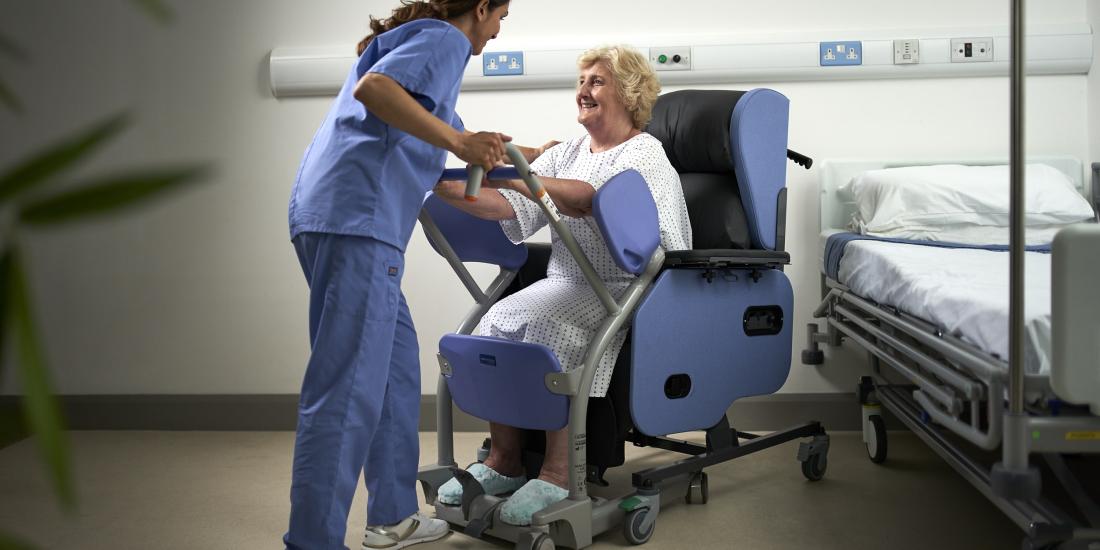 Patient in chair using standing aid Patient in chair using standing aid